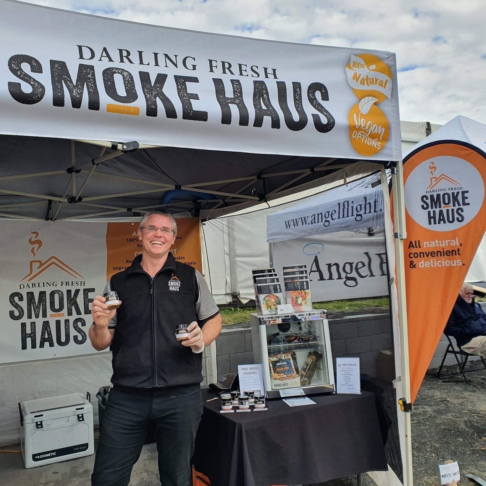 Jeff Schultheiss holding the new range of Wood-Smoked Seasonings at the DF Smoke Haus stall at FarmFest 2022